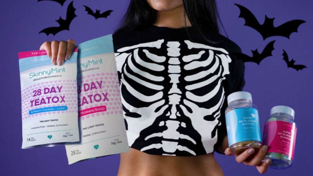 Model wearing Halloween costume and holding SkinnyMint 28 Day Teatox and Super Fat Burning Gummies